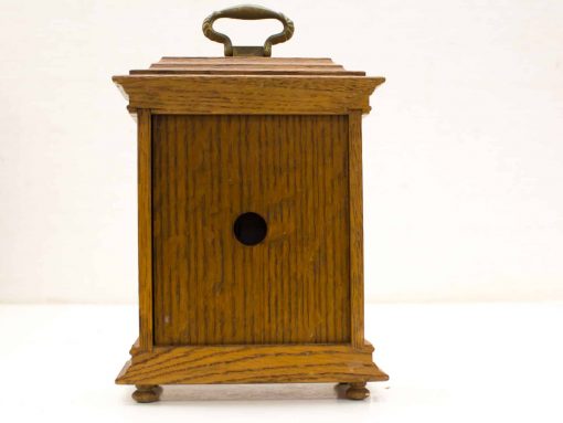 Vintage oak storage box with brass handle, perfect for organizing small items.