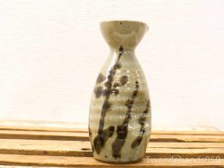 Elegant handmade ceramic vase in earthy tones with unique glaze and smooth contours.