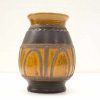 Artisan black and amber ceramic vase with elegant arches and contrasting textures.