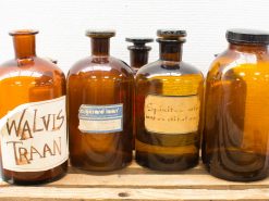 Vintage amber glass bottles showcasing unique designs and historical medicinal uses. Perfect for collectors.