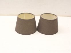 Elegant brown conical lampshades with black trim, perfect for adding warmth to any space.