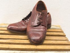 Elegant vintage brown leather shoes with broguing, perfect for formal occasions and timeless style.