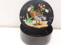 Vintage decorative container featuring a vibrant duck and floral design on a glossy finish.