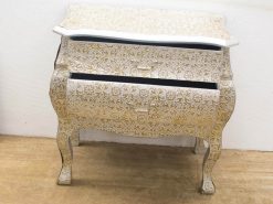 Elegant vintage chest of drawers with golden and white accents, beautifully crafted for stylish storage.