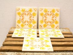 Vintage decorative tiles with floral designs for a warm and inviting home decor.