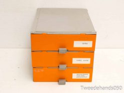 Vintage orange file cabinet with labeled drawers for organized document management and stylish workspace decor.