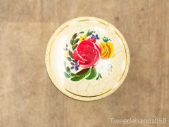 Elegant vintage table with floral design, featuring roses and a charming crackle finish.