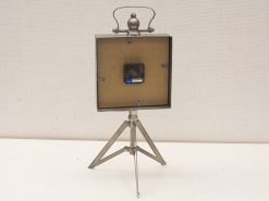 Antique photo projector on tripod, showcasing vintage design and craftsmanship for photography enthusiasts.