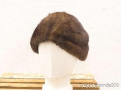 Vintage dark brown fur cloche hat with elegant fold, perfect for timeless fashion statements.