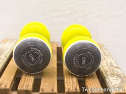 Bright yellow 3kg dumbbells on a rustic wooden surface for effective strength training.