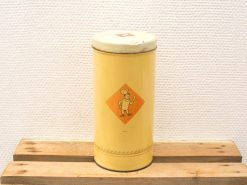 Vintage yellow tin canister featuring a playful chef illustration for charming kitchen storage.