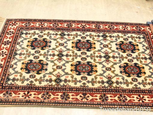 Vintage Persian rug with intricate patterns and vibrant colors, perfect for any interior space.