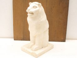 Elegant off-white lion sculpture with abstract design and LEONE inscription, ideal decor piece.