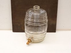 Vintage glass beverage dispenser with wooden tap, perfect for serving drinks at gatherings.