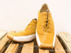 Chic golden yellow suede shoes with zipper and rubber sole for stylish comfort.