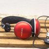 Vintage GRUNDIG headphones in glossy red with large ear cups and adjustable headband.