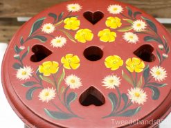 Hand-painted wooden stool with vibrant flowers, perfect for adding charm to any space.