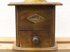 Vintage wooden storage box with metal plate, perfect for decor and functional use.