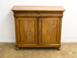 Elegant vintage wooden cabinet with sculpted doors and polished finish for stylish storage.