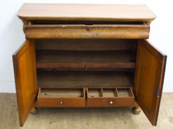 Vintage wooden cabinet with drawers, offering timeless charm and ample storage for any decor.