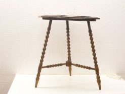 Vintage wooden table with turned legs, warm tone, and charming rustic details.