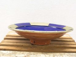 Vibrant terracotta dish with cobalt blue glaze, perfect as a centerpiece or decorative piece.