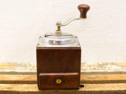 Vintage wooden coffee grinder with metal accents and practical drawer for fresh grounds.