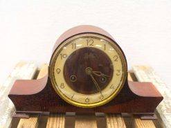 Vintage mahogany clock with elegant design, golden accents, and traditional numerals for timeless charm.