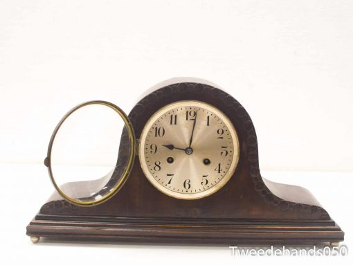 Elegant vintage wooden mantel clock with brass frame and intricate detailing, perfect for any decor.