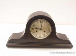 Elegant vintage mantel clock with wooden casing and classic Roman numerals, perfect for any decor.