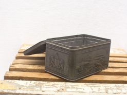 Vintage metal box with intricate embossing, perfect for collectors and rustic decor enthusiasts.