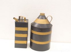 Vintage black metal containers with gold stripes, perfect for rustic decor and liquid storage.