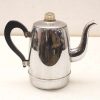 Elegant vintage stainless steel teapot with a comfortable black handle and timeless charm.