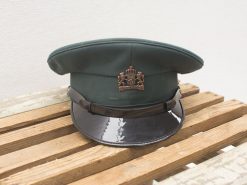 Vintage green military cap with royal insignia, embodying authority and tradition in design.