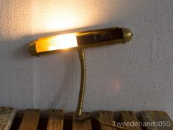 Stylish brass wall lamp with flexible arm for cozy, adjustable lighting in any space.