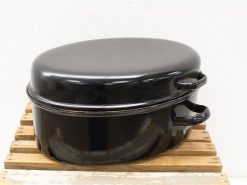 Vintage oval roasting pan with glossy black finish, ideal for elegant cooking and serving.