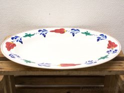 Vintage oval serving platter with vibrant floral design, ideal for any dining occasion.