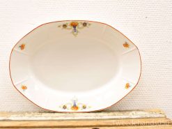 Elegant vintage oval serving platter with delicate orange and blue floral motifs.