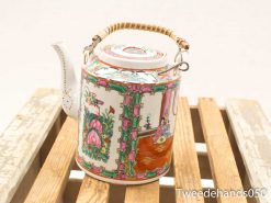 Intricately designed vintage hand-painted teapot with floral motifs and a unique braided handle.