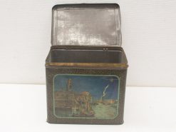 Vintage tin box with charming harbor illustration, perfect for storage or decorative display.