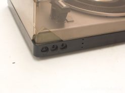 Classic vintage turntable with dust cover and precise tonearm for audio enthusiasts.