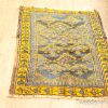 Elegant vintage geometric rug in blue and yellow, perfect for adding style and character.