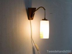 Stylish wall-mounted lamp with wood and glass, blending modern design and retro charm.