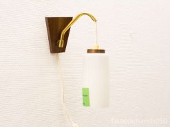 Stylish retro wall lamp in wood and brass with a modern glass shade for cozy illumination.