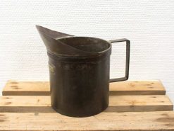 Rustic vintage metal jug with handle and high spout, perfect for decor or practical use.