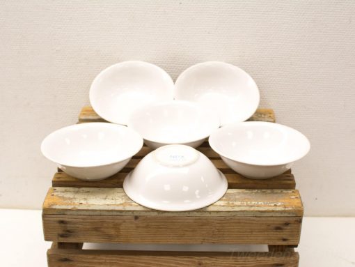 Elegant white bowls arranged on a rustic wooden crate, perfect for any dining occasion.