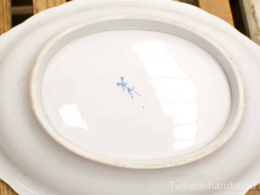 Elegant white porcelain platter with blue stamp, featuring a glossy finish and slight edge wear.