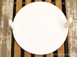 Modern white disc with handles on rustic wooden surface, perfect for kitchen use.