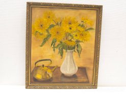 Vibrant sunflowers in an elegant white vase, radiating warmth and joy in a serene setting.