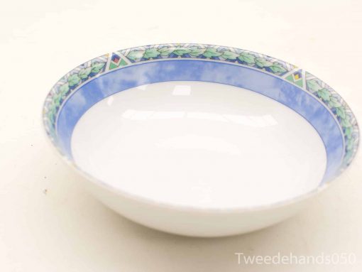 Elegant ceramic bowl with blue band and leaf pattern, perfect for dining and decoration.